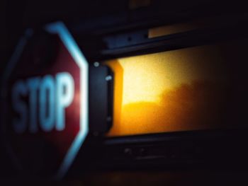 Close-up of illuminated text on car windshield at night