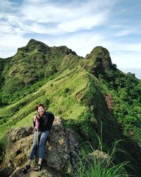 Portrait of man standing on mountain against sky