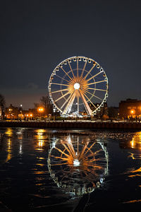 Illuminated ferris wheel at night