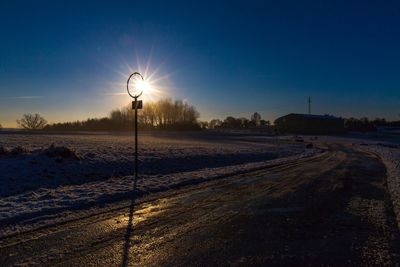 Scenic view of field against clear blue sky at night