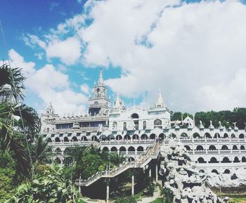 Low angle view of historical building against cloudy sky