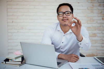 Mid adult man using laptop on table