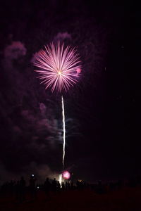 Low angle view of firework display at night