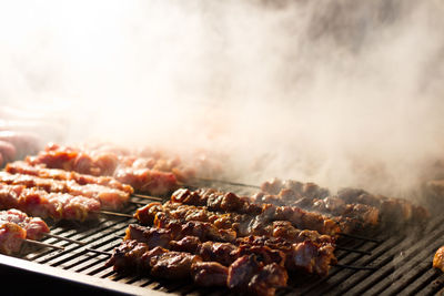 Close-up of meat skewers on barbecue grill