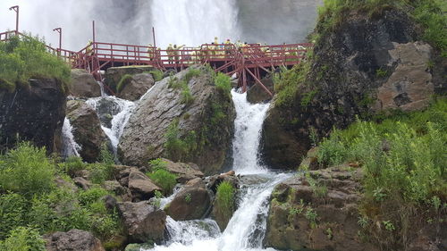 Scenic view of waterfall against sky