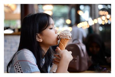 Teenage girl eating ice cream