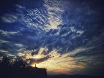 Low angle view of dramatic sky during sunset