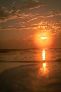 Scenic view of sea against romantic sky at sunset