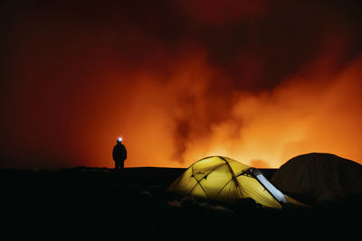 Man volcano light tent camping night