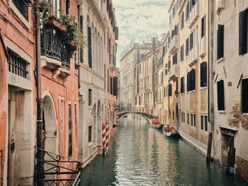 Canal amidst buildings in city