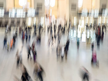 Blurred motion of people walking in city