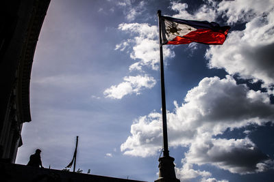 Low angle view of flag against sky