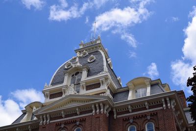 Low angle view of building against cloudy sky