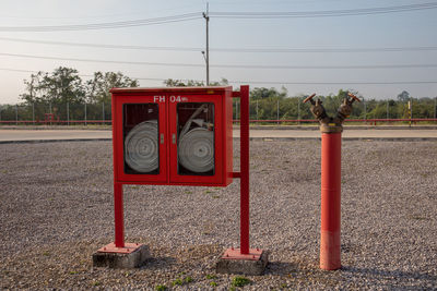 Red fire hydrant on field against sky