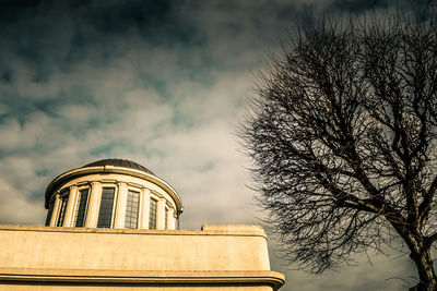 Low angle view of building against cloudy sky