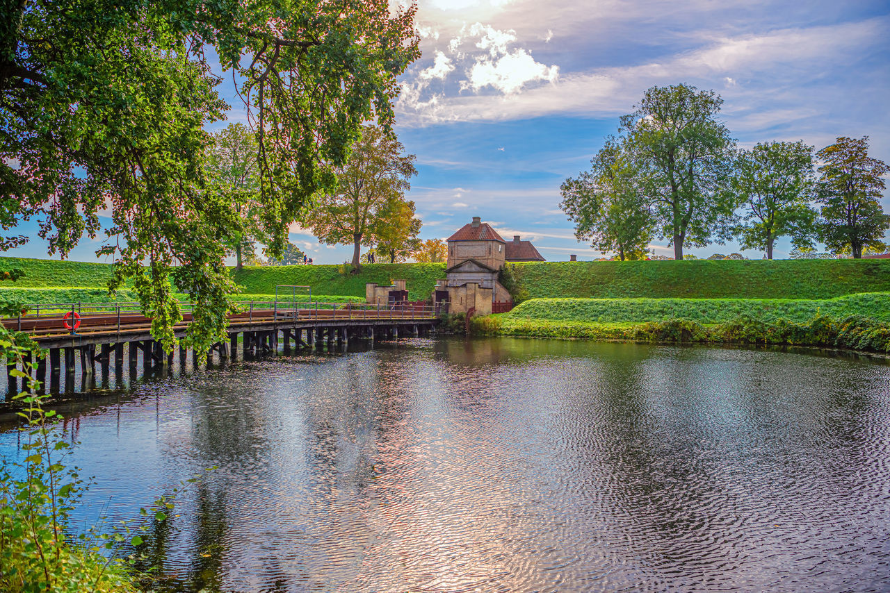 water, reflection, architecture, tree, plant, built structure, sky, nature, river, building, landscape, cloud, environment, travel destinations, travel, building exterior, religion, beauty in nature, tourism, scenics - nature, pond, history, tranquility, no people, autumn, house, rural area, the past, outdoors, temple - building, rural scene, place of worship, sunset, bridge, garden, waterway, belief, flower, summer, mansion, tradition, city, grass, business finance and industry, residential district, land, blue, social issues, vacation, estate