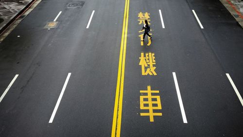 High angle view of woman crossing road