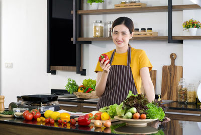 Portrait of smiling young man standing at home