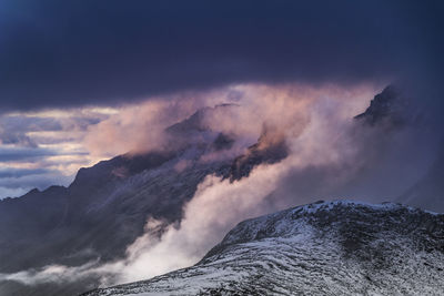 Scenic view of mountains against cloudy sky