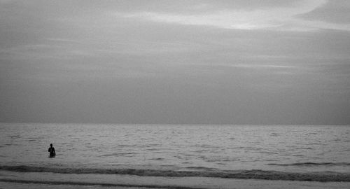 Man standing on beach against sky