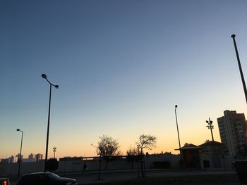 Low angle view of silhouette street light against clear sky