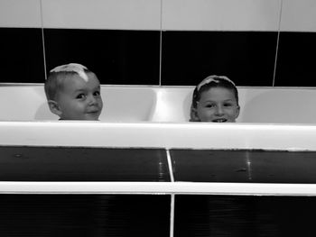 Cute siblings enjoying in bathtub at home