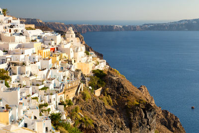 High angle view of townscape by sea against sky