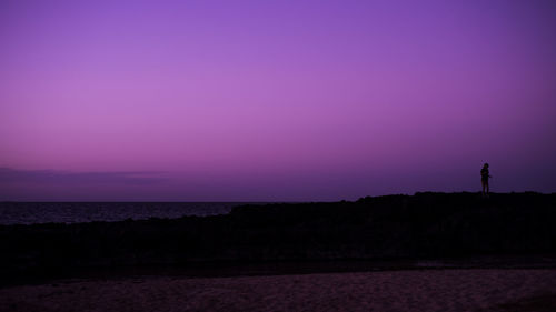 Scenic view of sea against clear sky at sunset