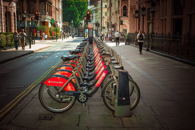 People riding bicycle on road in city