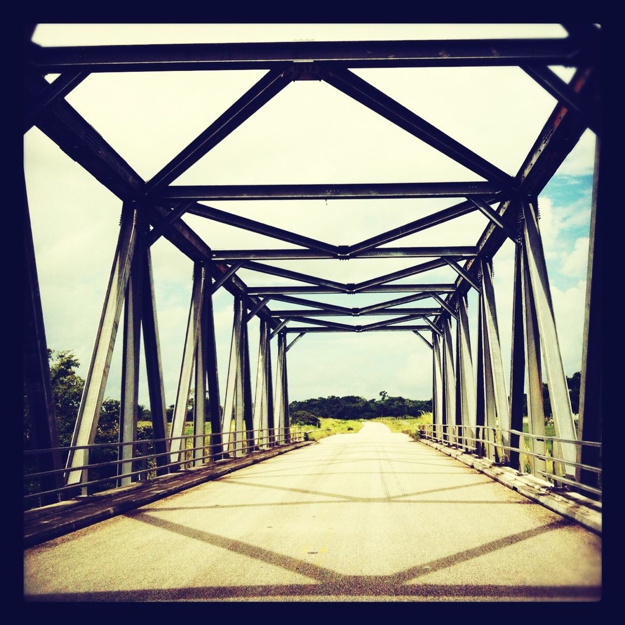 the way forward, diminishing perspective, transportation, connection, vanishing point, bridge - man made structure, built structure, sky, long, architecture, road, railing, metal, engineering, no people, empty, outdoors, clear sky, bridge, day