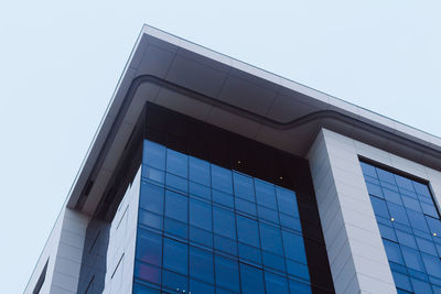 Low angle view of modern building against clear blue sky