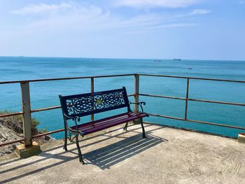 Chairs on beach against sky