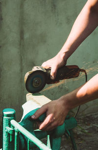 Cutting a metal plate with an electric grinder. hand work concept, industry and construction