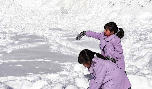 Full length of woman on snow field during winter