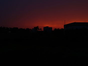 Silhouette cityscape against sky during sunset