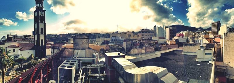 Buildings against cloudy sky