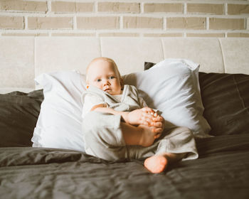 Cute baby lying on bed at home