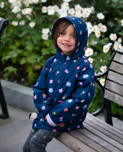 Portrait of a smiling girl sitting on bench