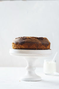 Close-up of cake on table against white background