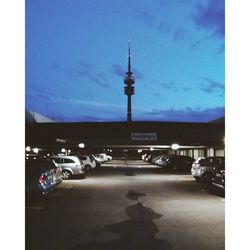 Cars on road against cloudy sky