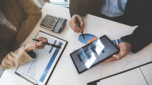 High angle view of business colleagues working on table