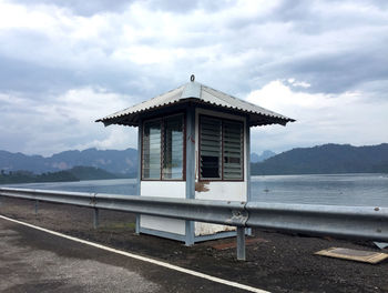 Built structure by sea against sky