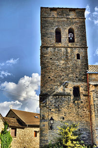 Low angle view of building against cloudy sky