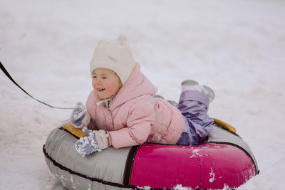 Dad giving high five little girl on walk in winter snowy day.