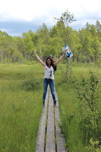 Rear view of woman standing on grass