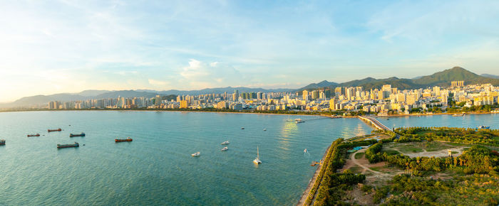 Scenic view of sea and city against sky