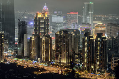 Illuminated modern buildings in city at night