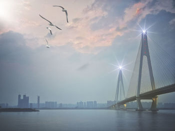 Bridge over river with buildings in background