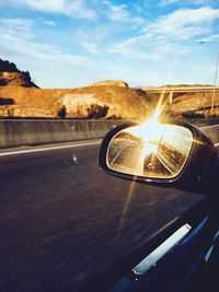 Close-up of car on road against sky