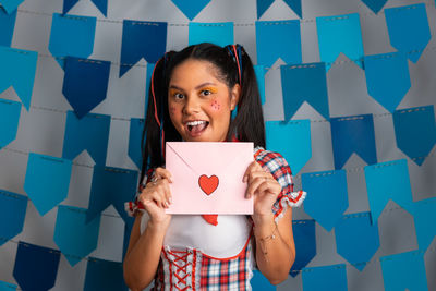 Portrait of young woman reading map